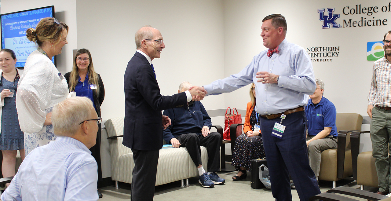 Group gathering with two people shaking hands