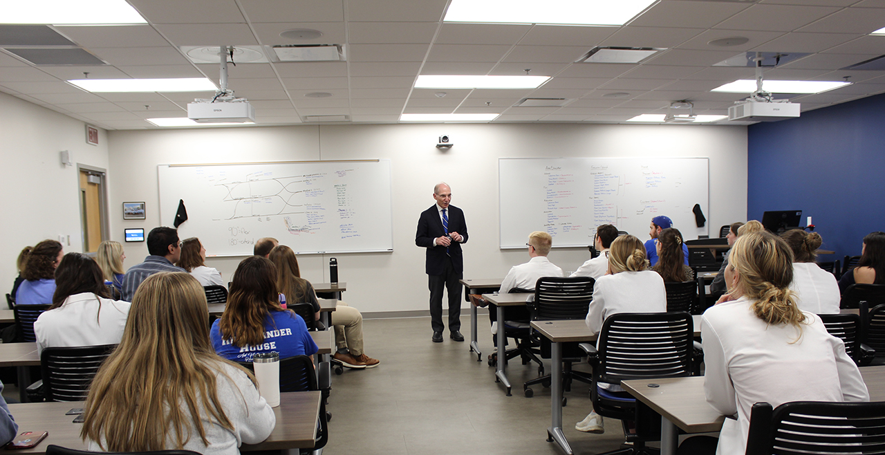 Image of a man speaking in a classroom