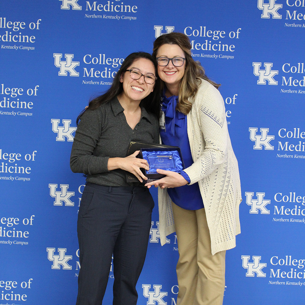 Two people together getting an award