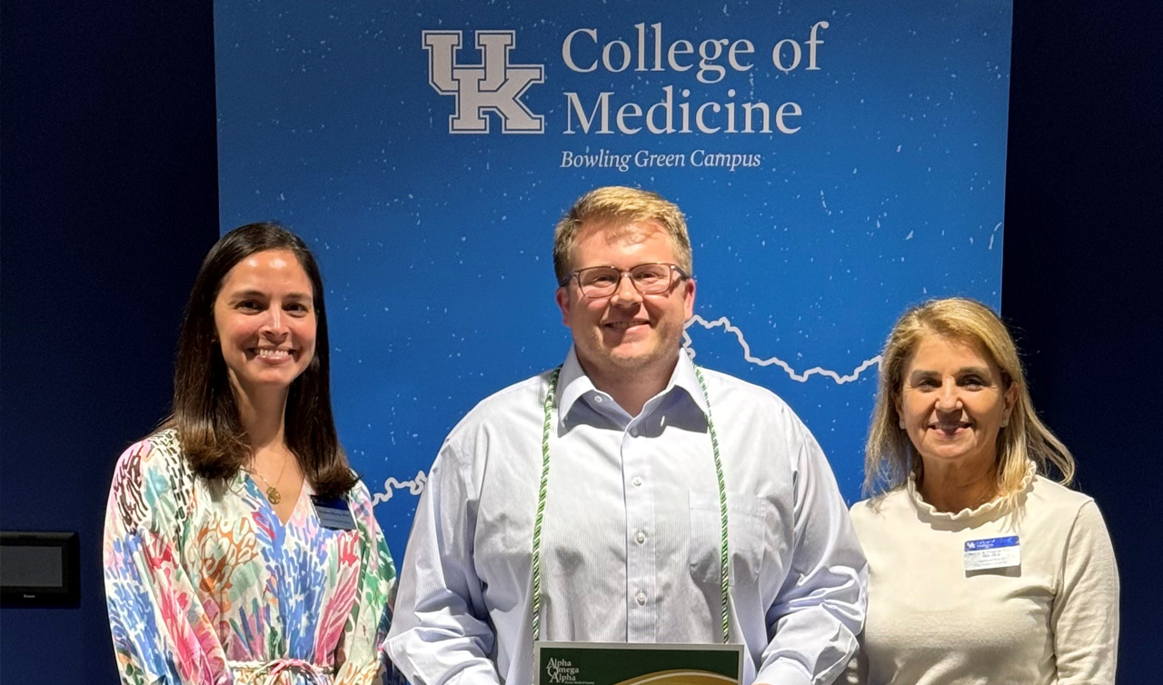 Dean Griffith giving an award to a group of people.